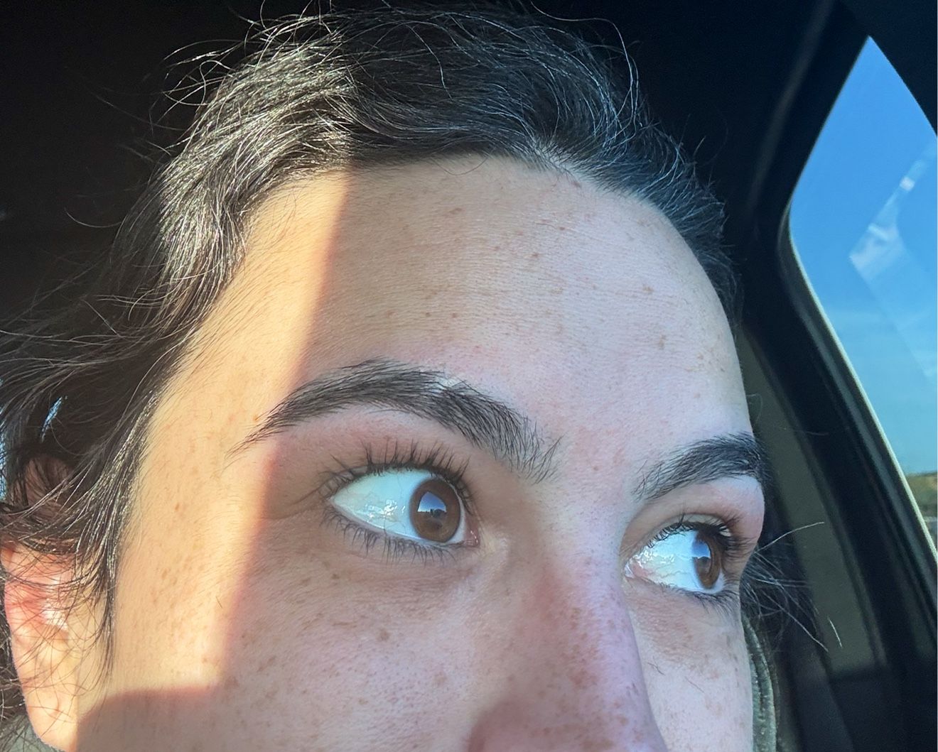 Close-up of a client's freshly threaded eyebrow