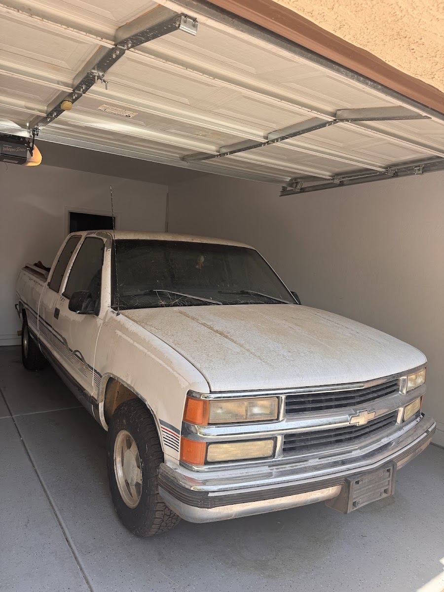 White Chevy pickup truck parked in a garage