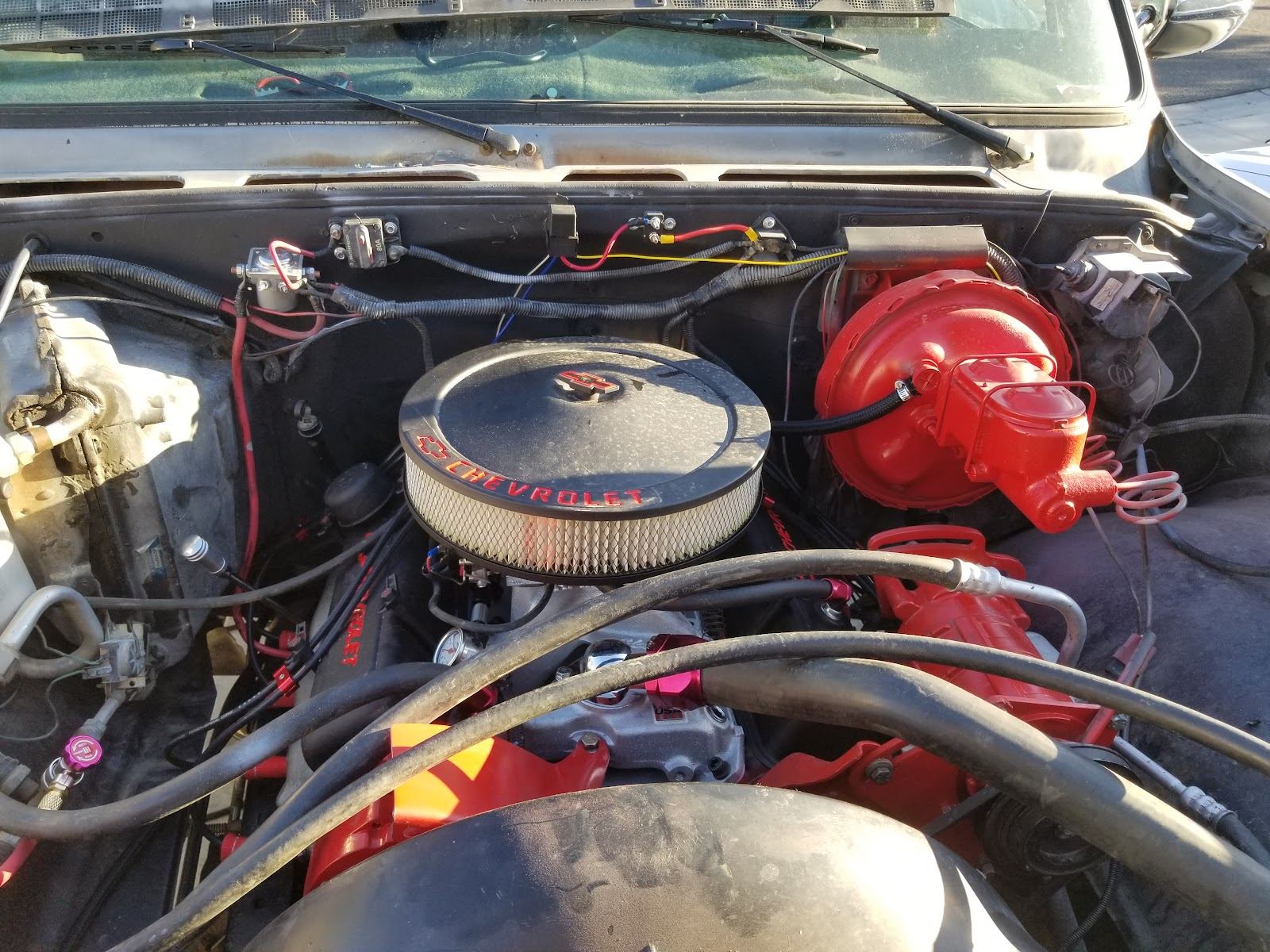 Under the hood of a Chevy with a red small block engine