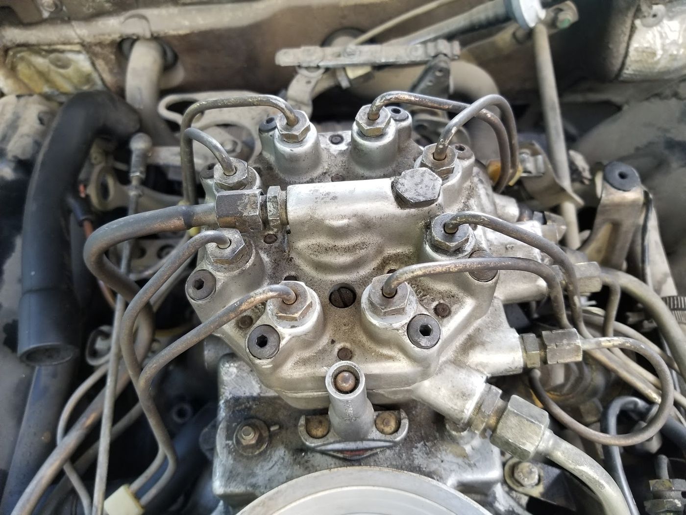 Close up of an engine fuel pump with steel lines