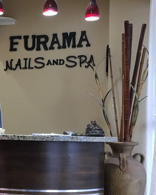 The Furama Nails and Spa sign above the reception desk