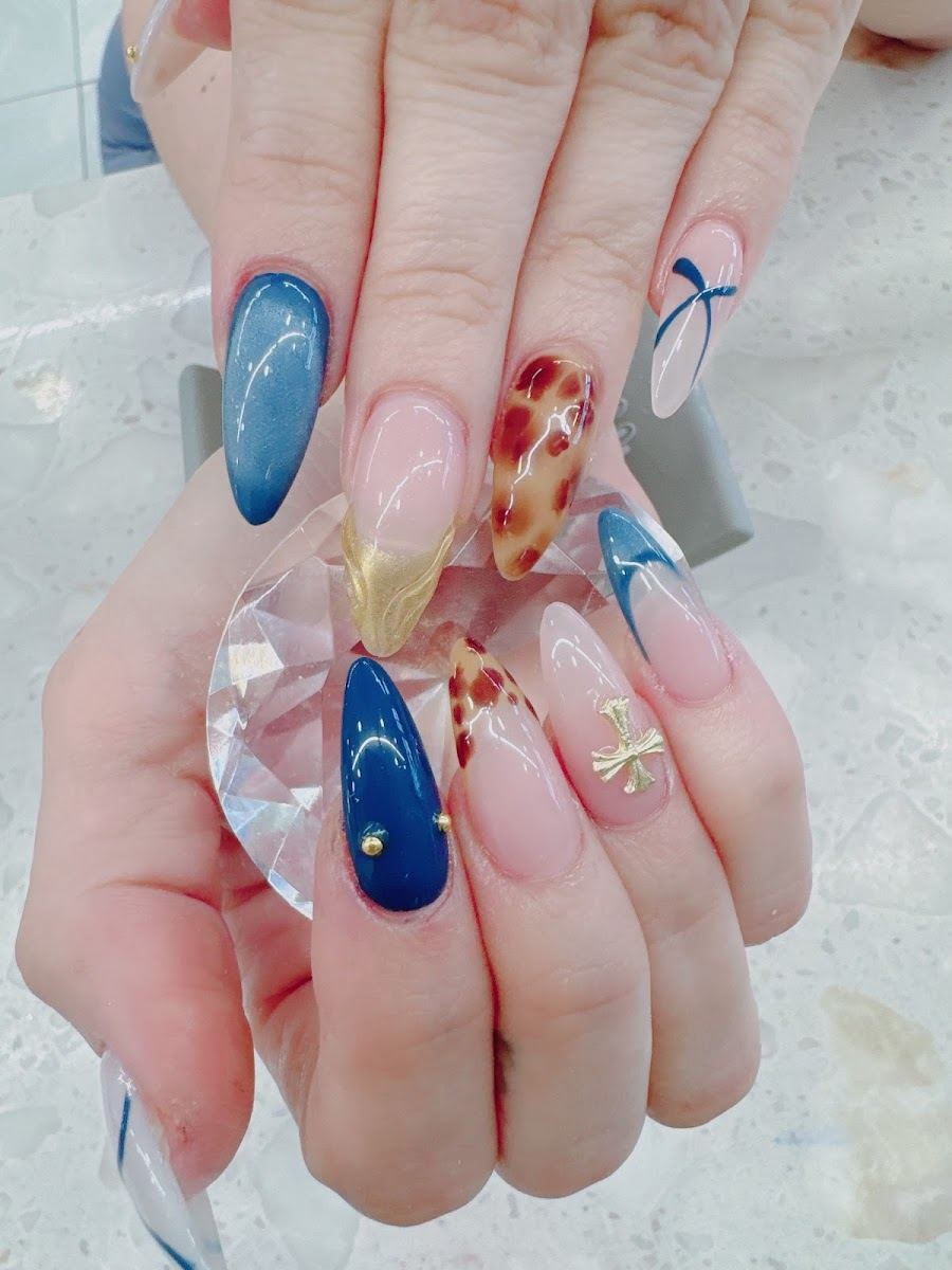 Mixed nail art set with navy, gold and red floral accent nails