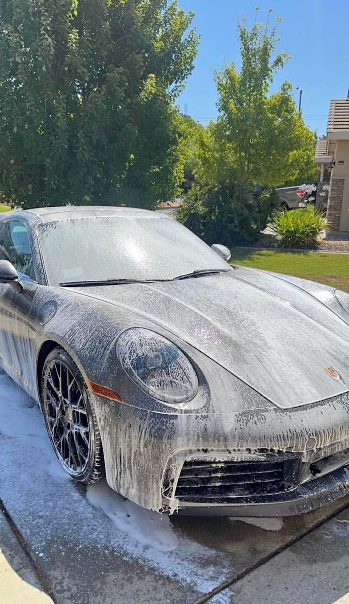 Porsche 911 covered in snow foam during the pre-wash