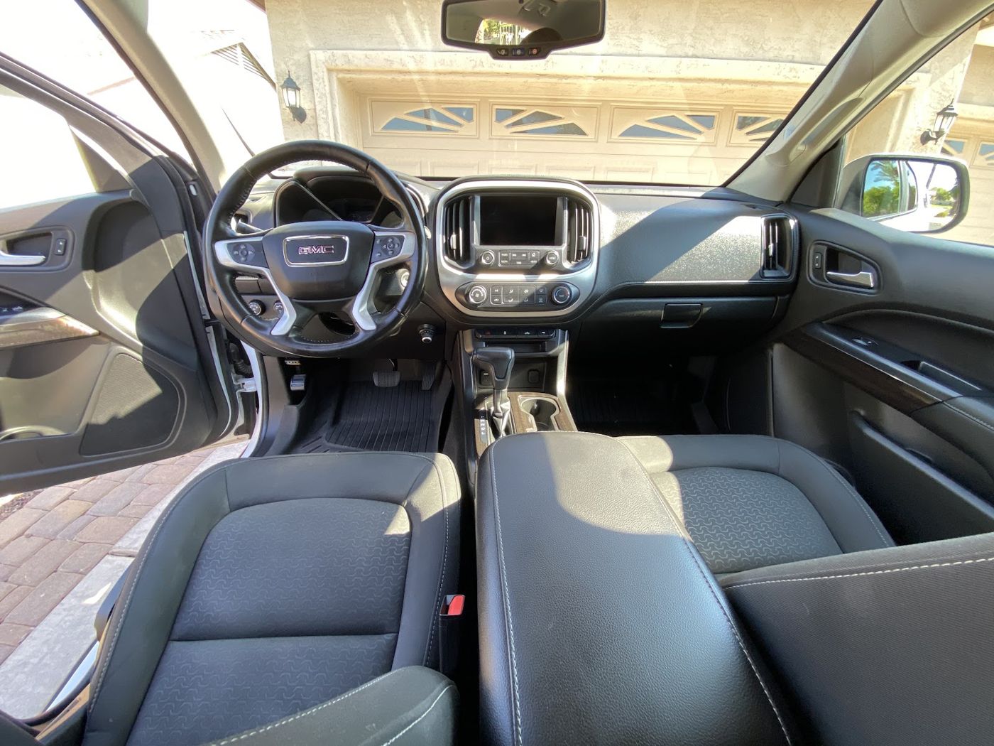 Clean GMC cabin with spotless dash, console and seats after an interior detail