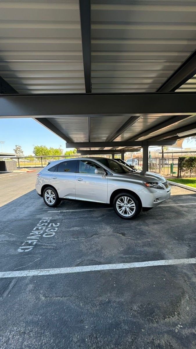 Silver SUV parked under a covered carport after a wash