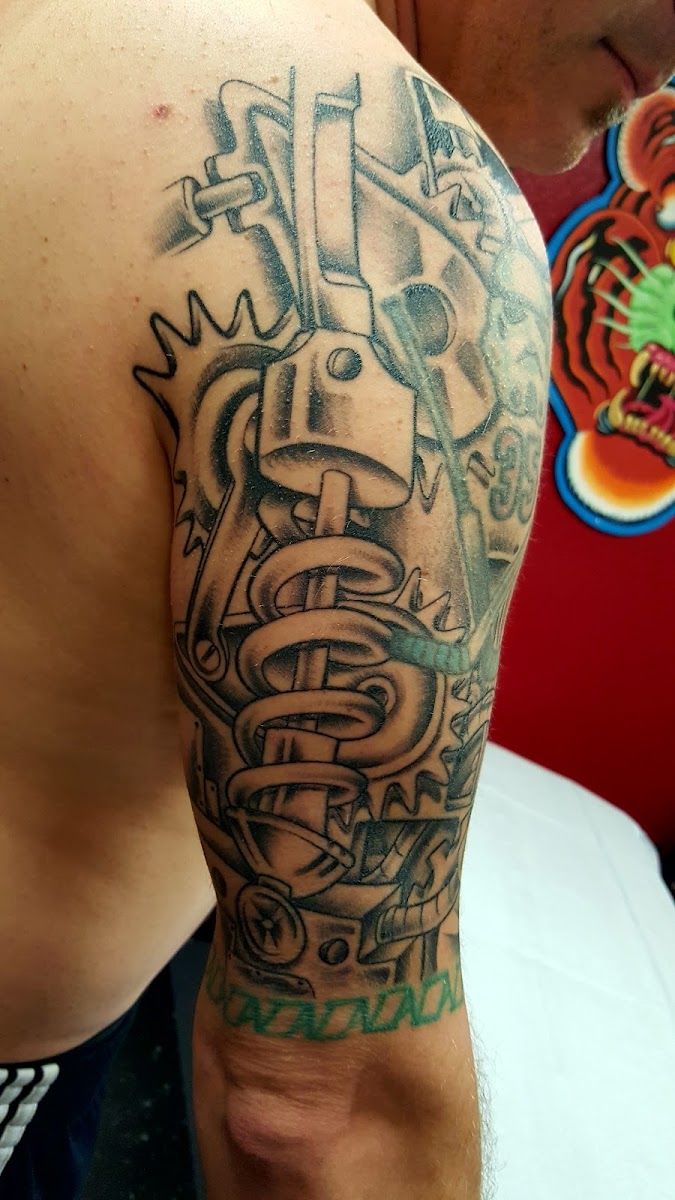Black and grey biomechanical tattoo on an upper arm