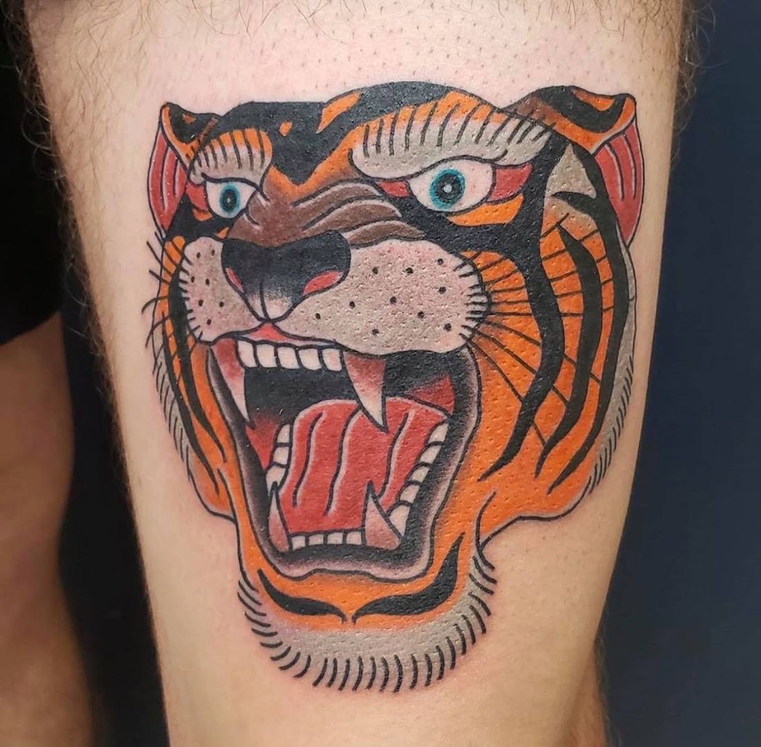 Traditional tiger head tattoo in orange and red