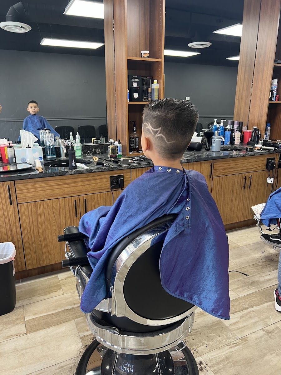 Young client getting a fresh cut in the chair