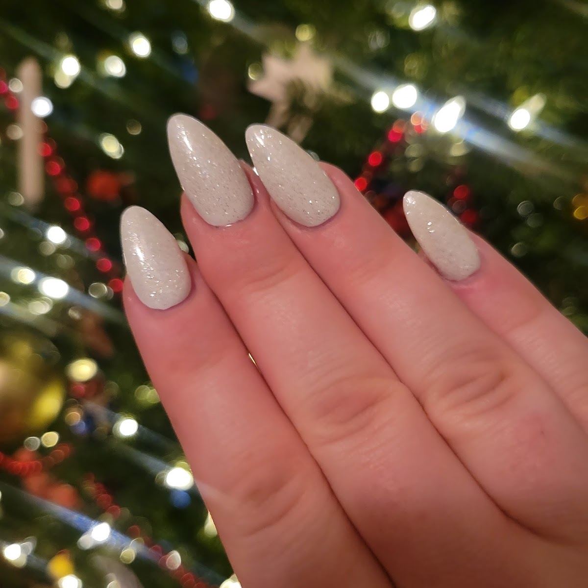 Long almond nails in a shimmering nude polish