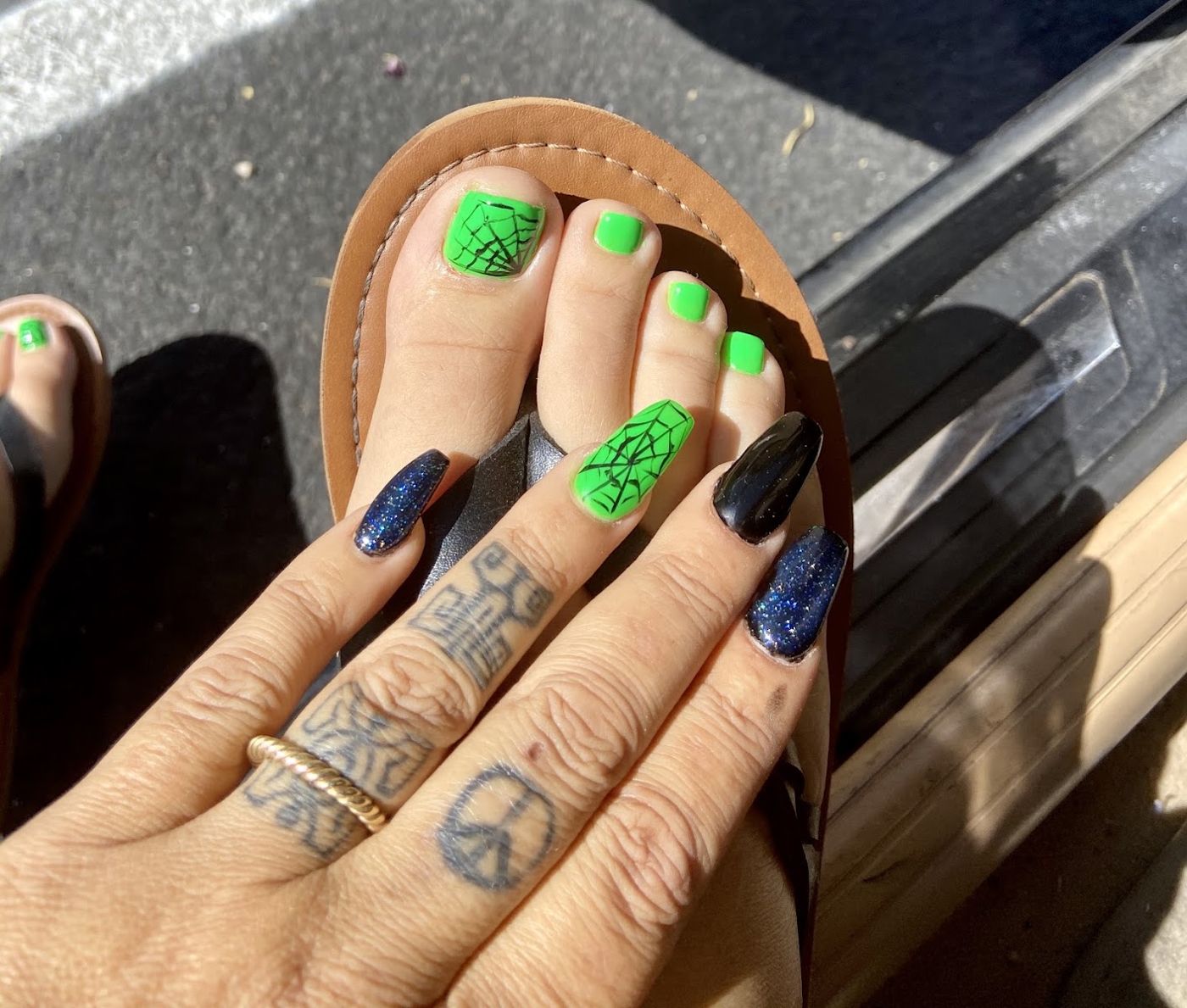 Pedicure in bright green with a spiderweb accent toe