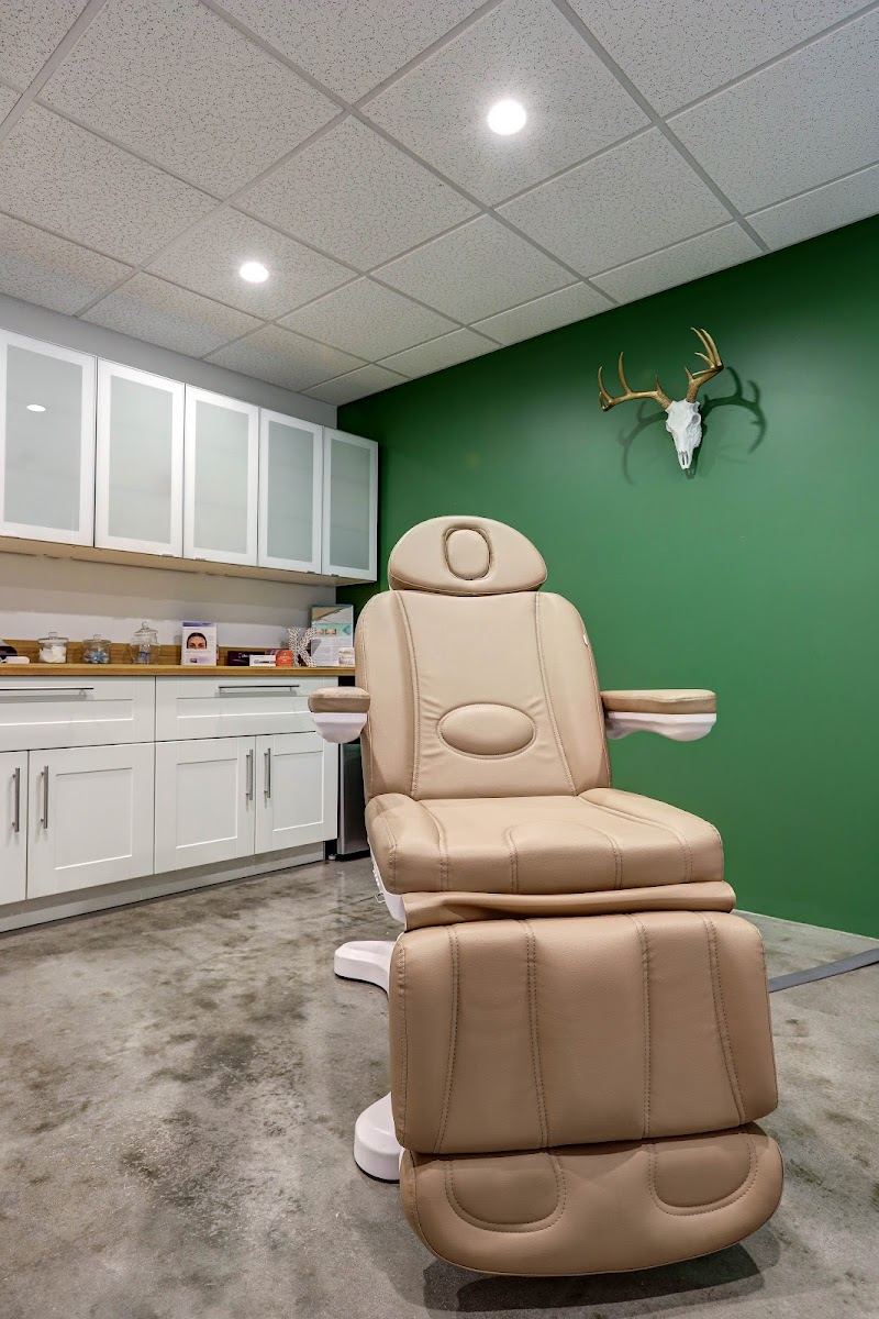 A treatment chair against a deep green wall
