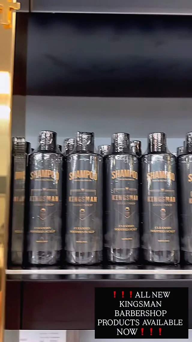 A shelf of black Kingsman Barbershop shampoo bottles