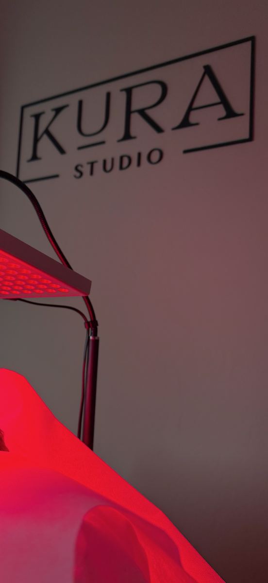 Boxed KURA STUDIO wordmark sign on the studio wall