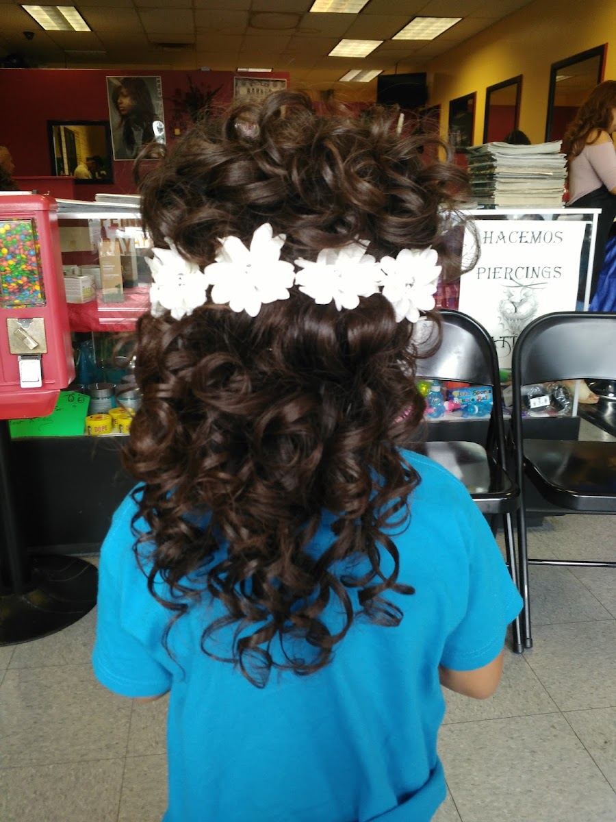 Curly updo pinned with a band of white flowers
