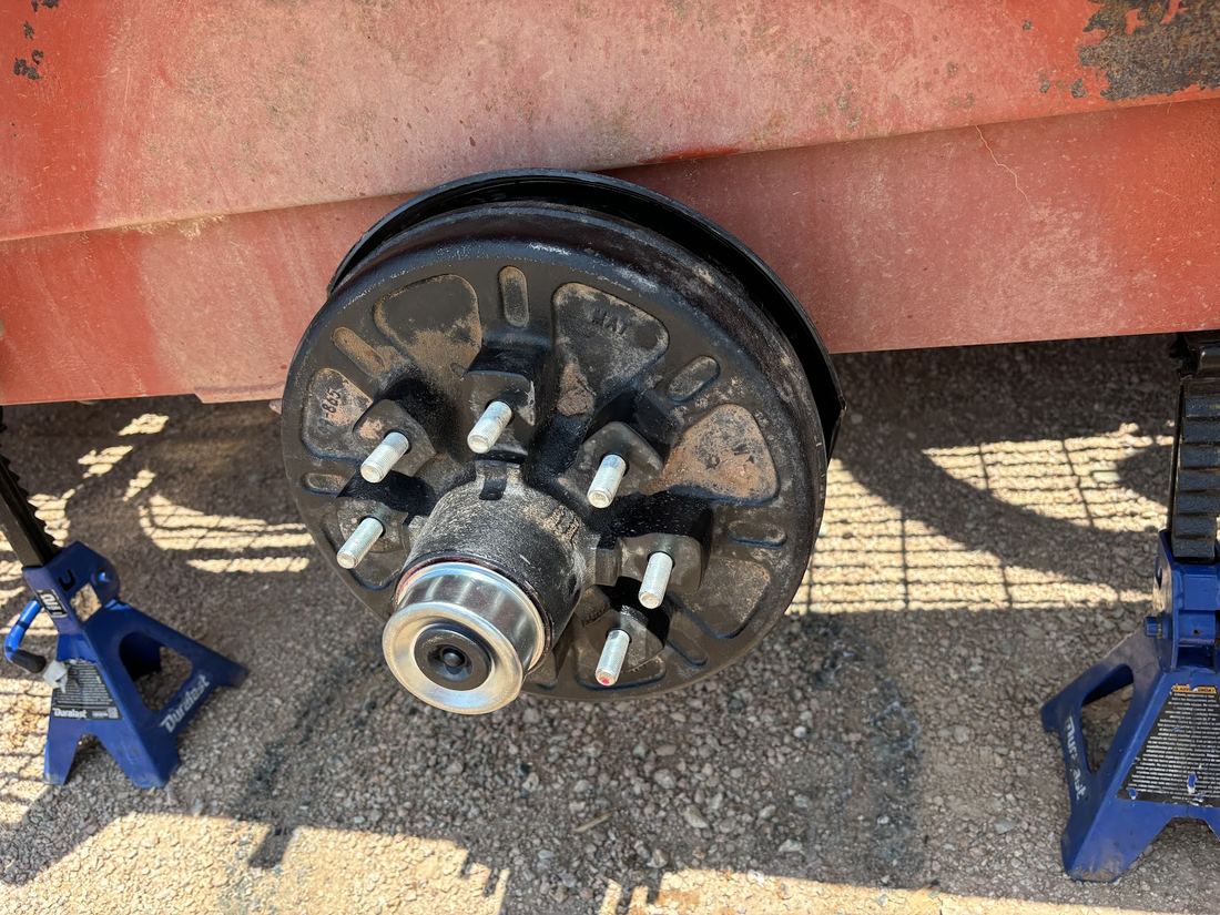 Wheel hub supported on blue jack stands with the wheel off