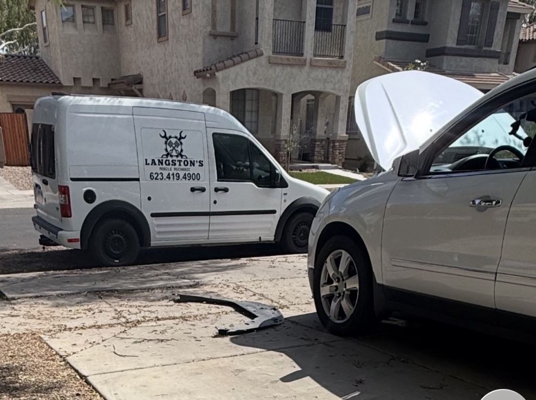 Langston’s service van parked beside a customer’s SUV with the hood open in a residential driveway