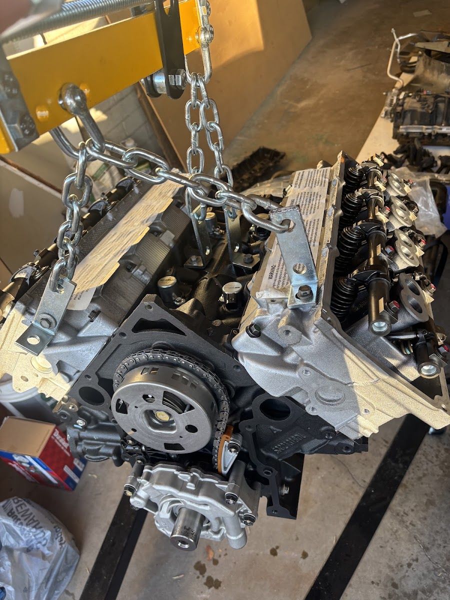 Engine block hanging from a chain hoist