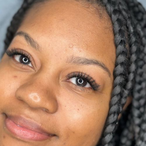 Client smiling with natural lash extensions