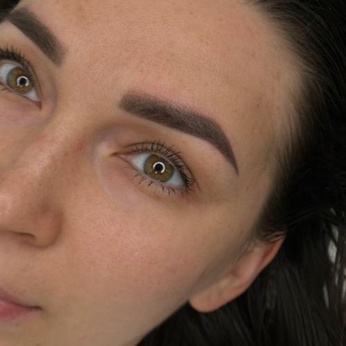 Shaped and tinted brows framing hazel eyes