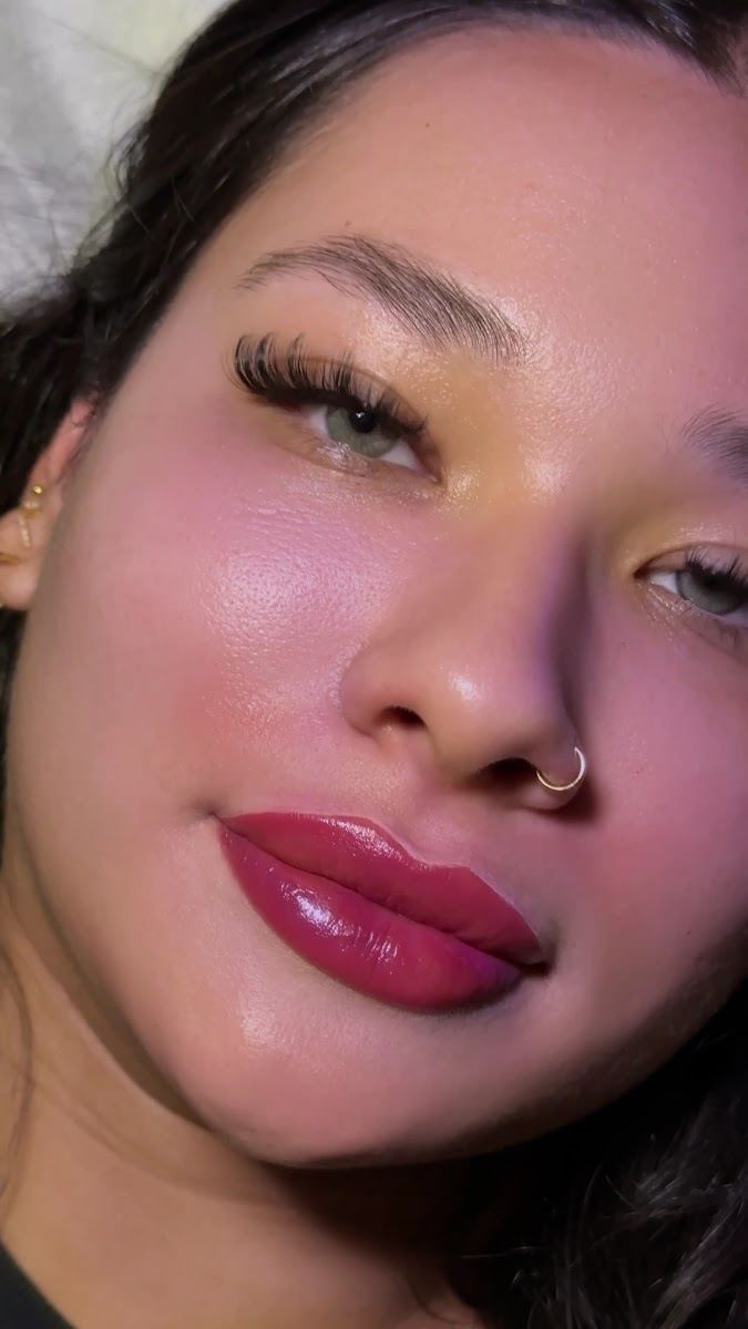 Lip blush in a berry shade with lash extensions