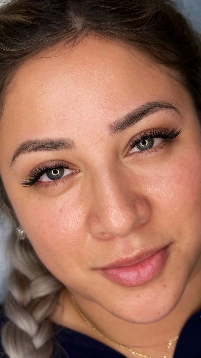 A client with soft natural lash extensions after her appointment
