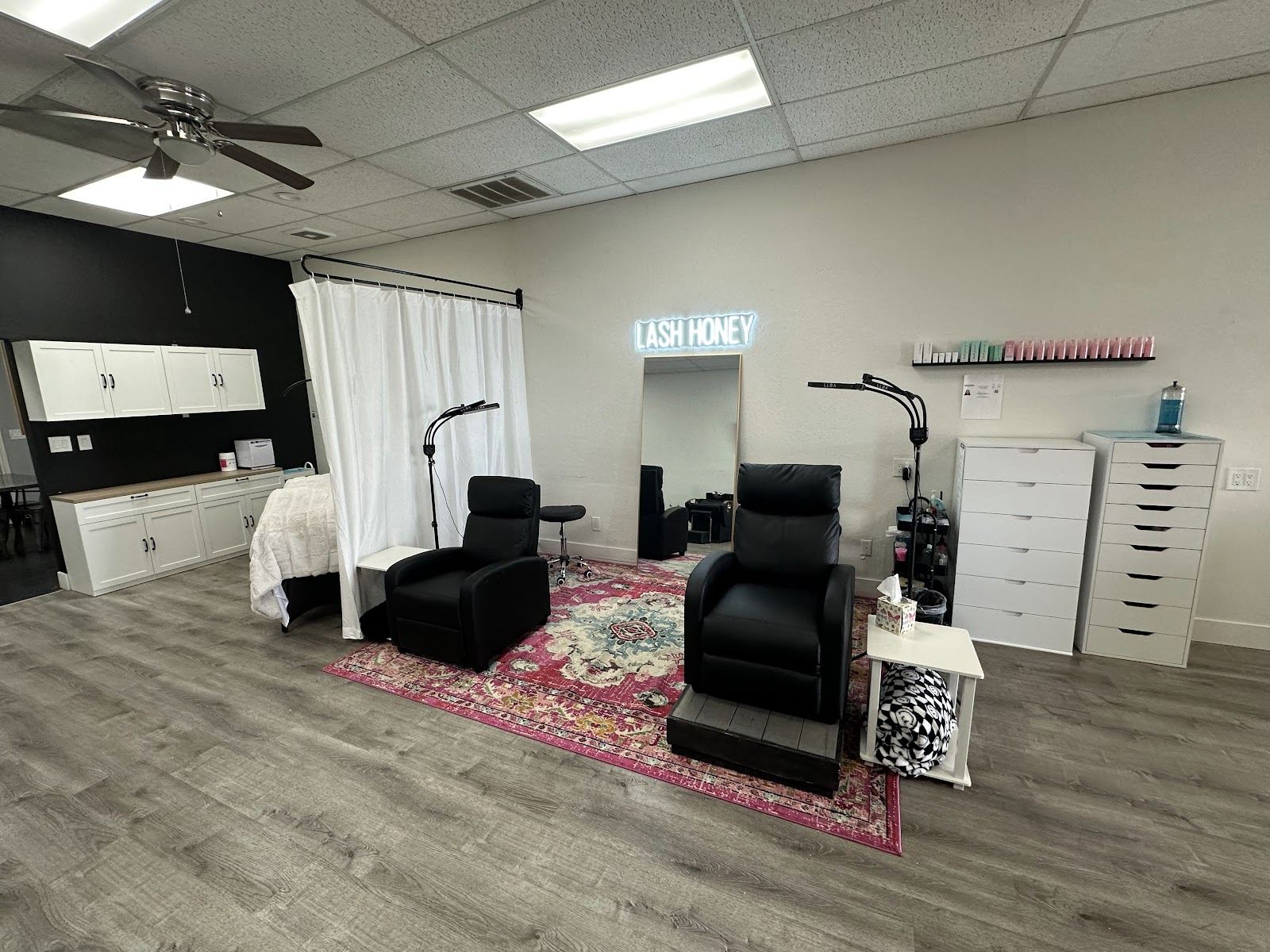 Inside the Lash Honey studio in Mesa: lash beds, a gold mirror and the glowing Lash Honey sign