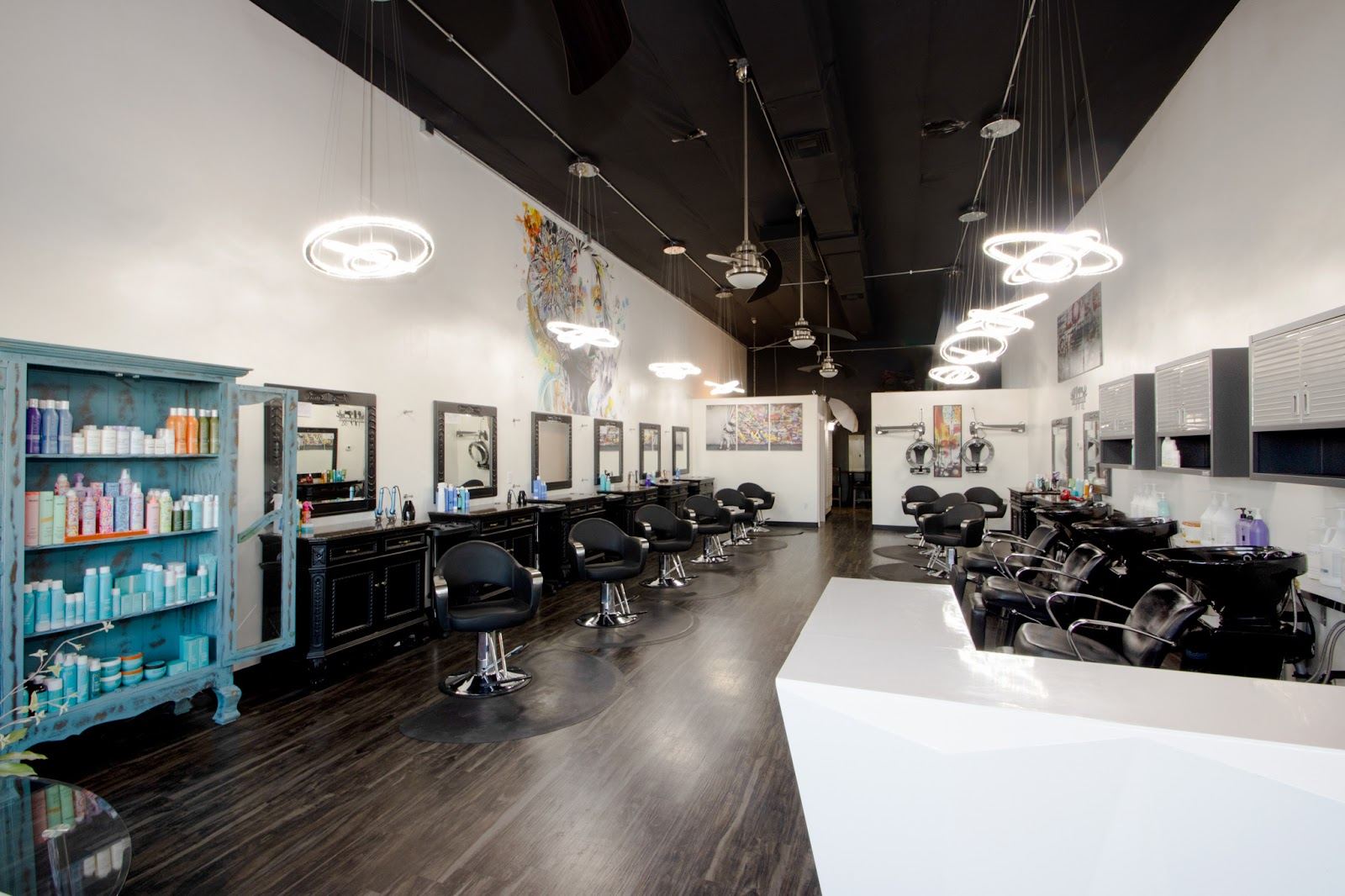 Inside Last Chance Salon: a long row of styling chairs and mirrors under ring lights