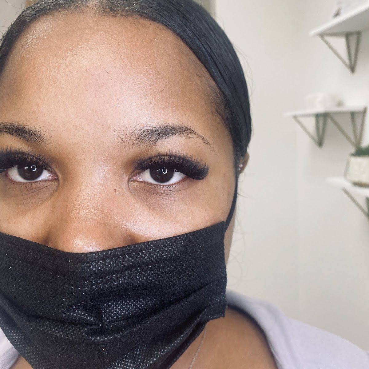 Client with a dark, full lash set looking into the camera