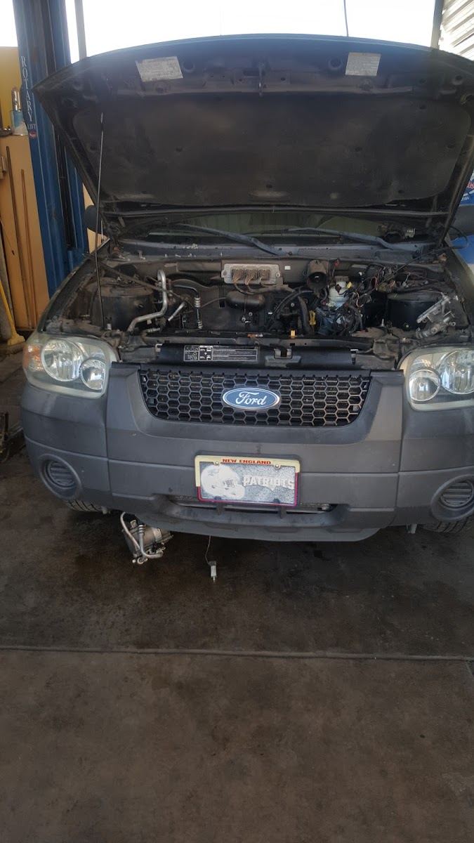 Gray Ford SUV in the bay with its hood open