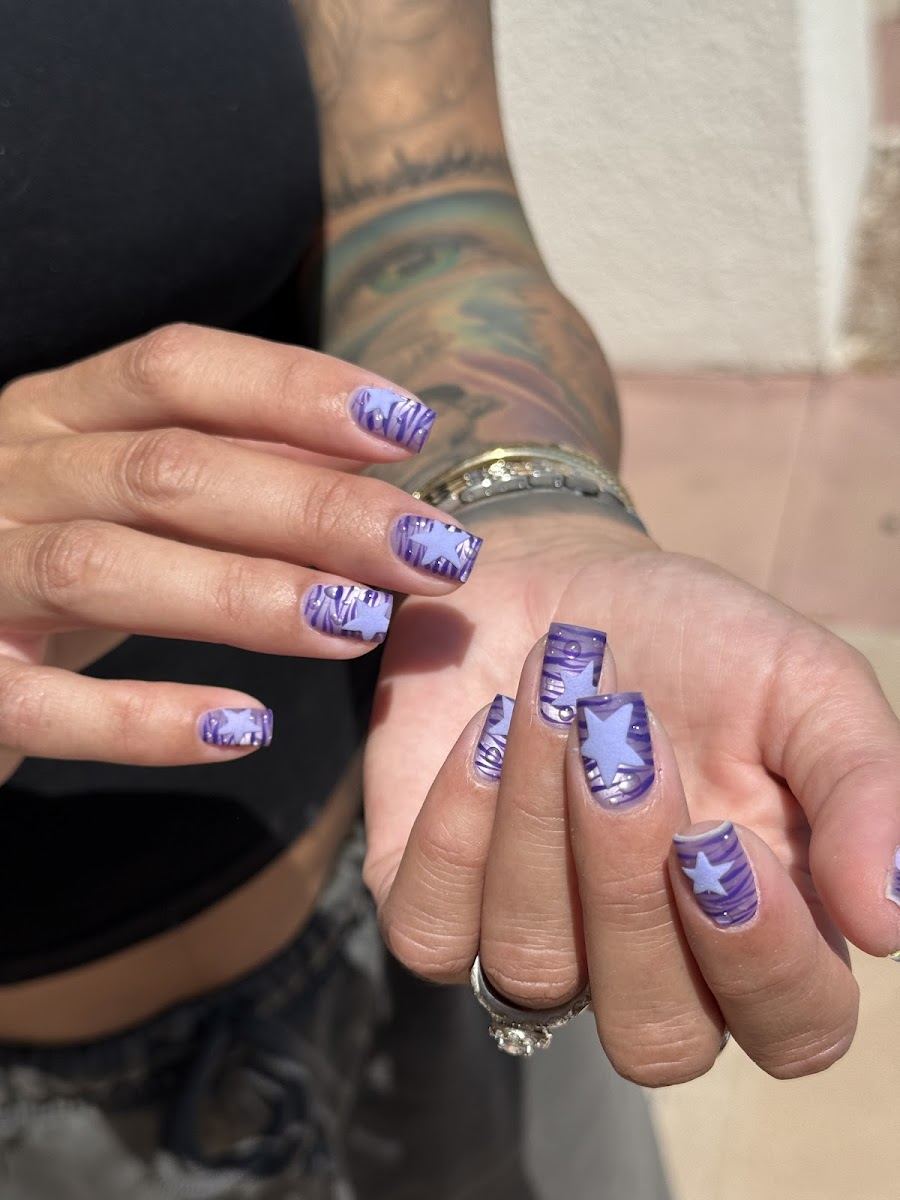 Short lavender nails with purple star and zebra art