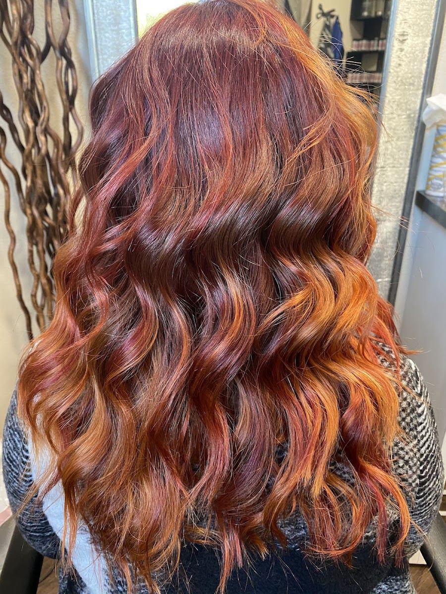 Long copper and auburn waves seen from behind