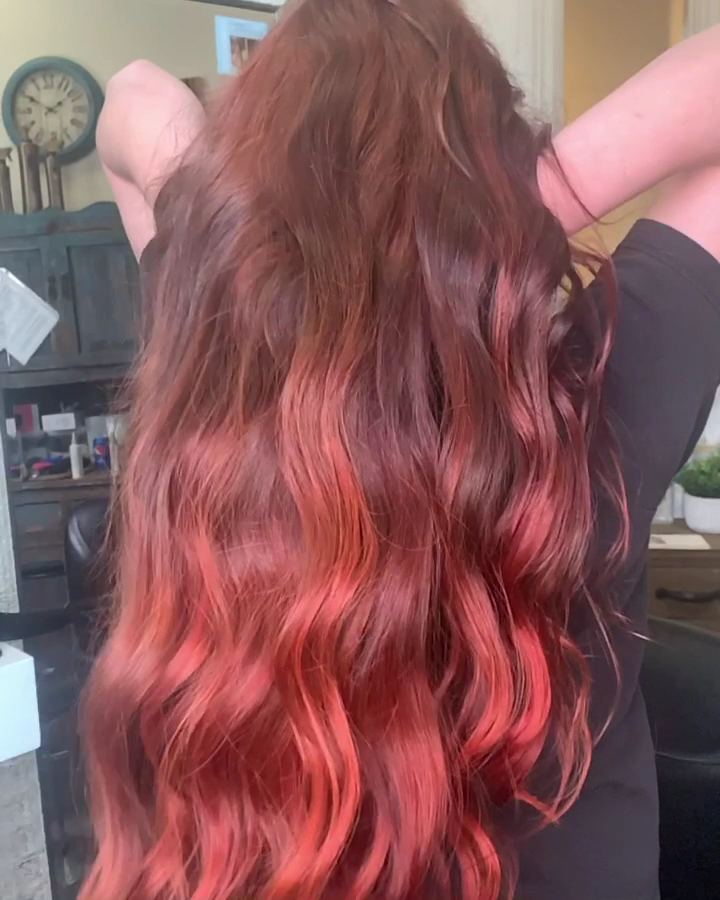 Dark red hair melting into bright coral red ends