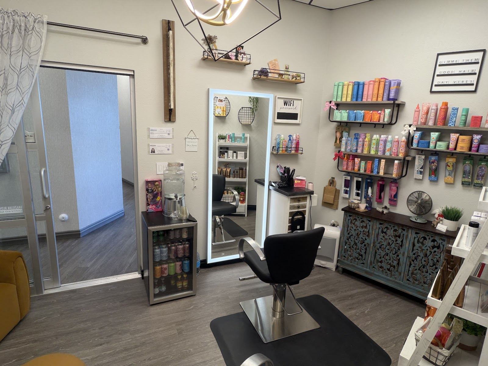 Inside the LUXurious Salon suite: styling chair, mirror and shelves of color products