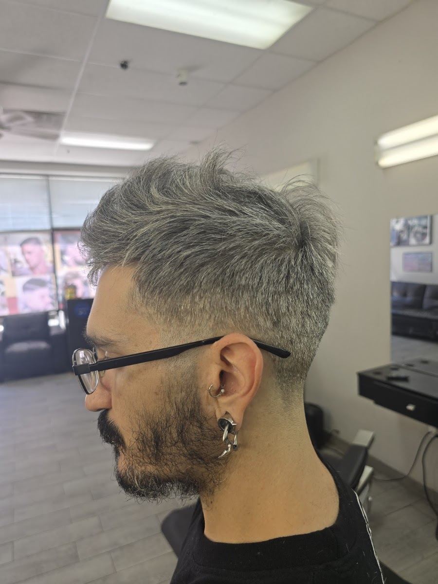 Client with silver hair cut into a textured crop with a tapered neckline and lined up beard