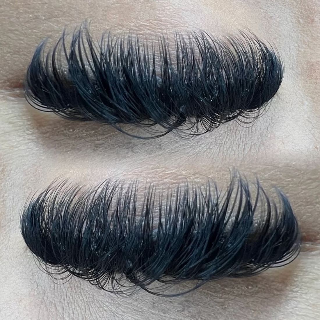 Close-up of a full set of dark lash extensions