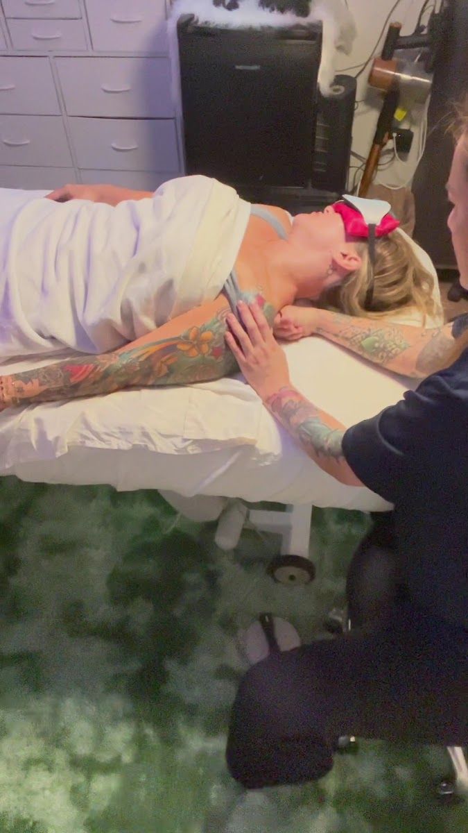 Massage session on the treatment table at the studio