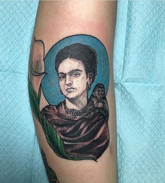 Color portrait tattoo of a woman with a monkey and calla lily on a forearm