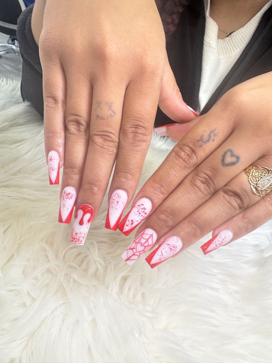 Long almond nails in pink and white with hand-painted pink details
