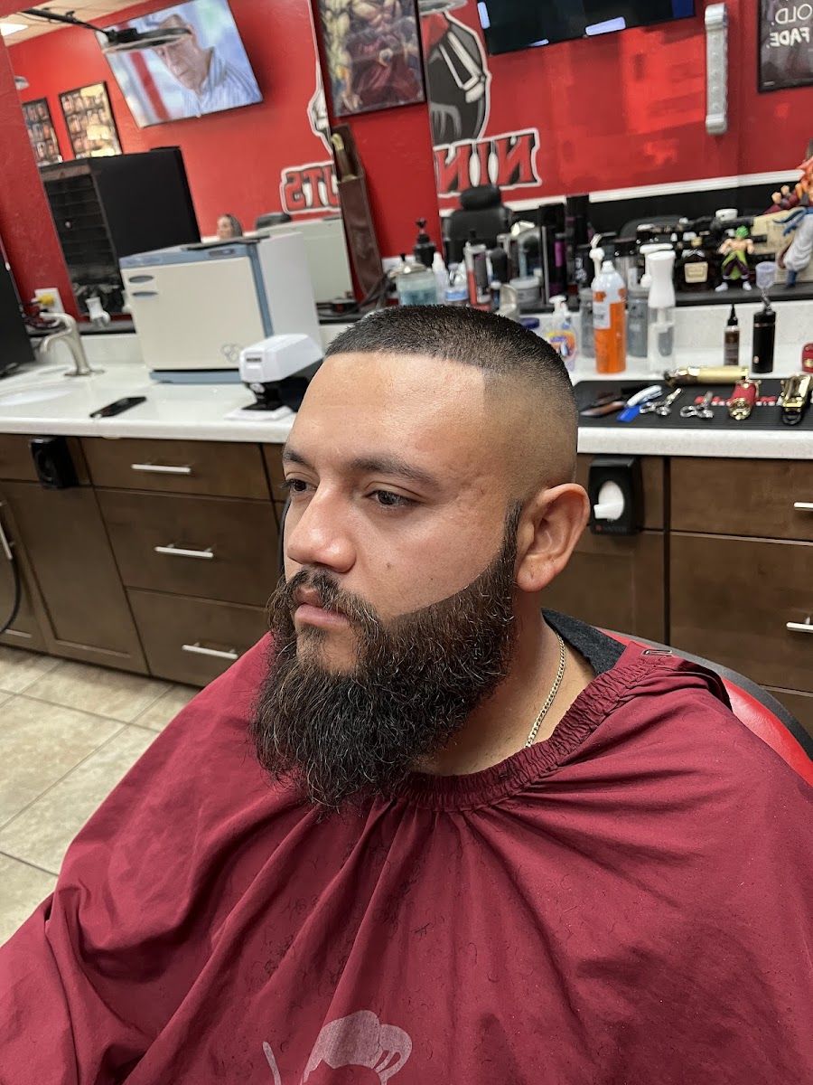Client with a full shaped beard and short cut in the chair