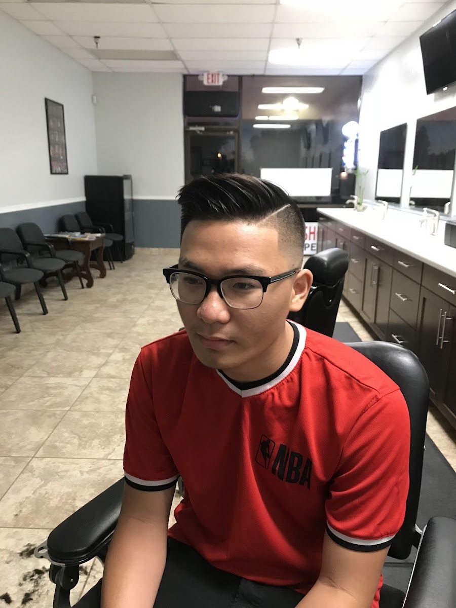 Client in glasses showing a fresh side part cut