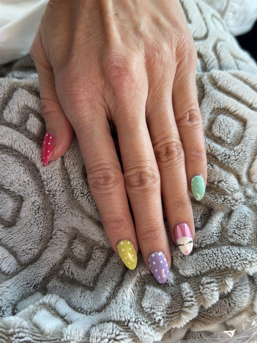 Pastel nails with polka dot and glitter accents
