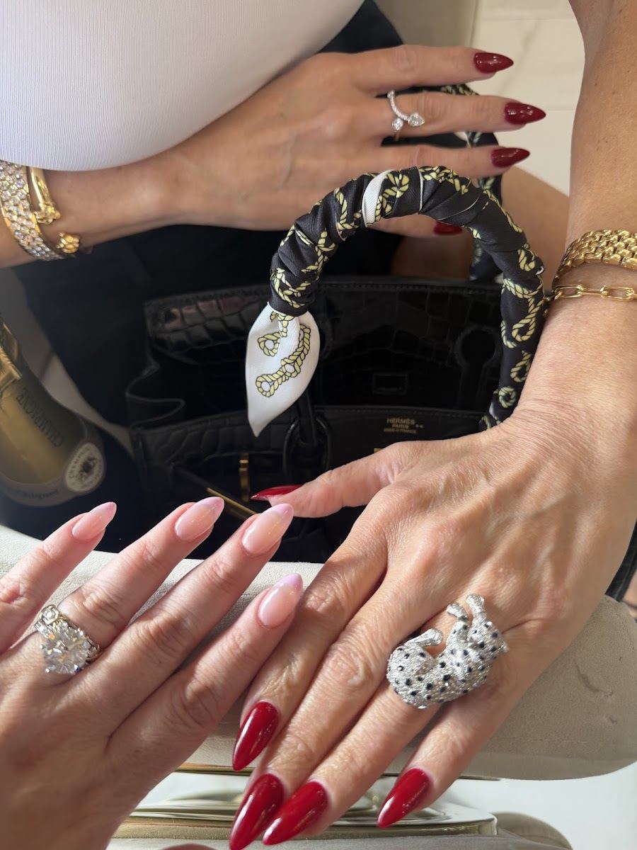 Glossy long red nails with silver rings