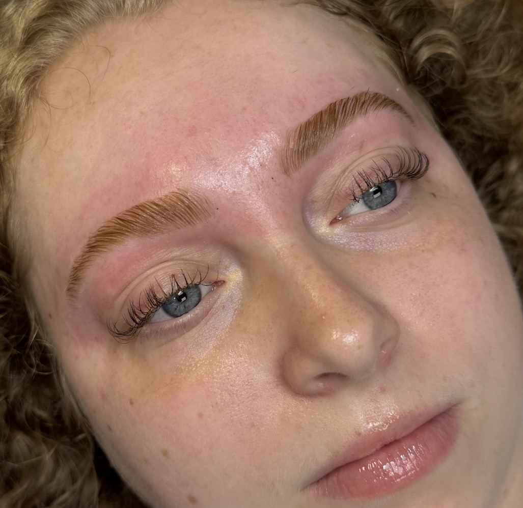 Laminated, tinted brows with lifted lashes on a client