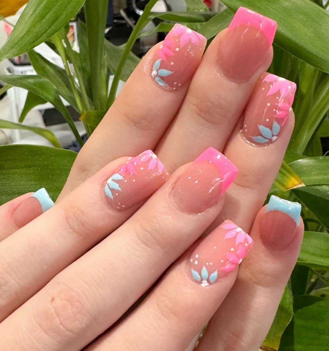 Pink ombre nails with tiny blue flower accents