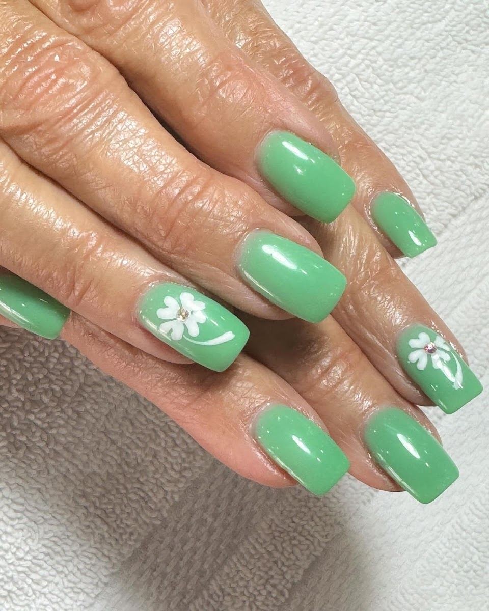 Mint green nails with white flower art