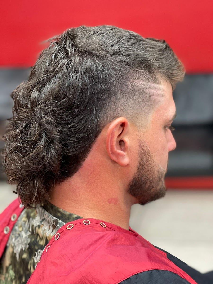 Textured mullet with a skin fade and a carved line design