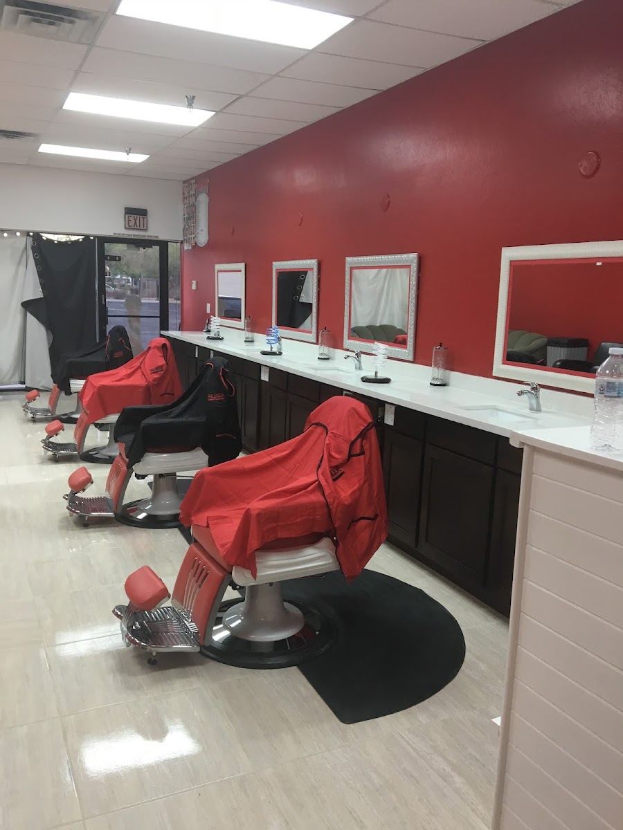 Red barber chairs lined up along the red wall inside Palenque barbershop