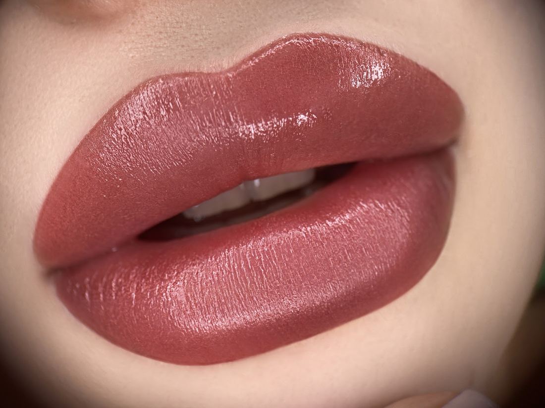 Macro close-up of lips after lip blushing, a soft rose color