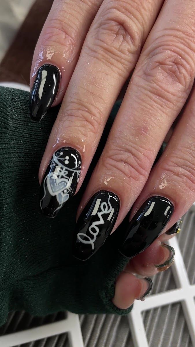 Glossy black almond nails with white line art