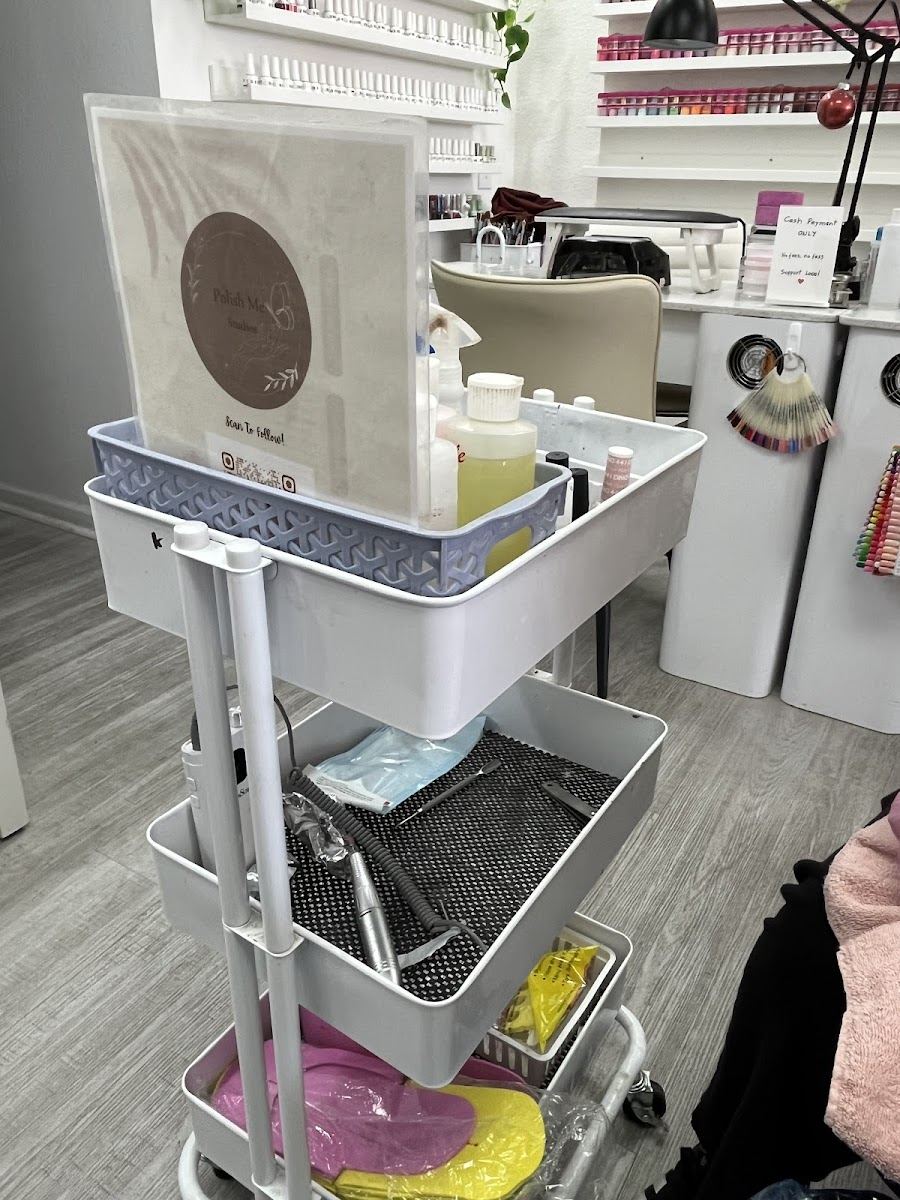 A tidy manicure station and supply cart at the studio